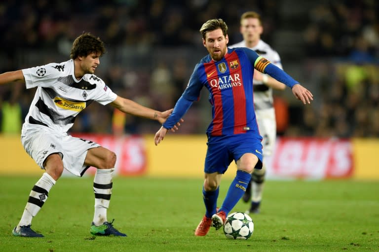 Barcelona's forward Lionel Messi (R) vies with Moenchengladbach's defender Tobias Strobl during the UEFA Champions League Group C football match FC Barcelona vs Borussia Moenchengladbach at the Camp Nou stadium in Barcelona, on December 6, 2016