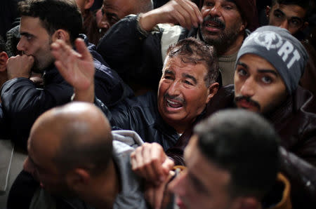 A man gestures as he asks for a travel permit to cross into Egypt through the Rafah border crossing after it was opened by Egyptian authorities for humanitarian cases, in the southern Gaza Strip February 8, 2018. REUTERS/Ibraheem Abu Mustafa