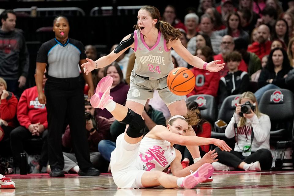 Feb 13, 2023; Columbus, OH, USA;  Ohio State Buckeyes guard Taylor Mikesell (24) reacts to a travelling violation by Indiana Hoosiers guard Grace Berger (34) during the first half of the NCAA women’s basketball game at Value City Arena. Mandatory Credit: Adam Cairns-The Columbus Dispatch