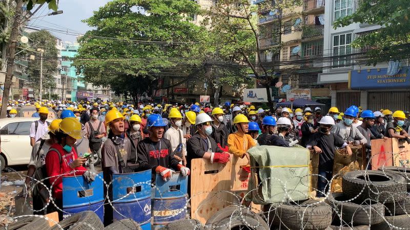 Video grab of protesters shouting slogans behind a barricade in Sanchaung, Yangon, Myanmar