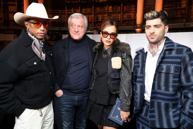 <p>Pascal Le Segretain/Getty</p> (Left to right) Pharrell Williams, Sidney Toledano, Rita Ora and Zayn Malik attend the Kenzo Menswear show at Paris Fashion Week