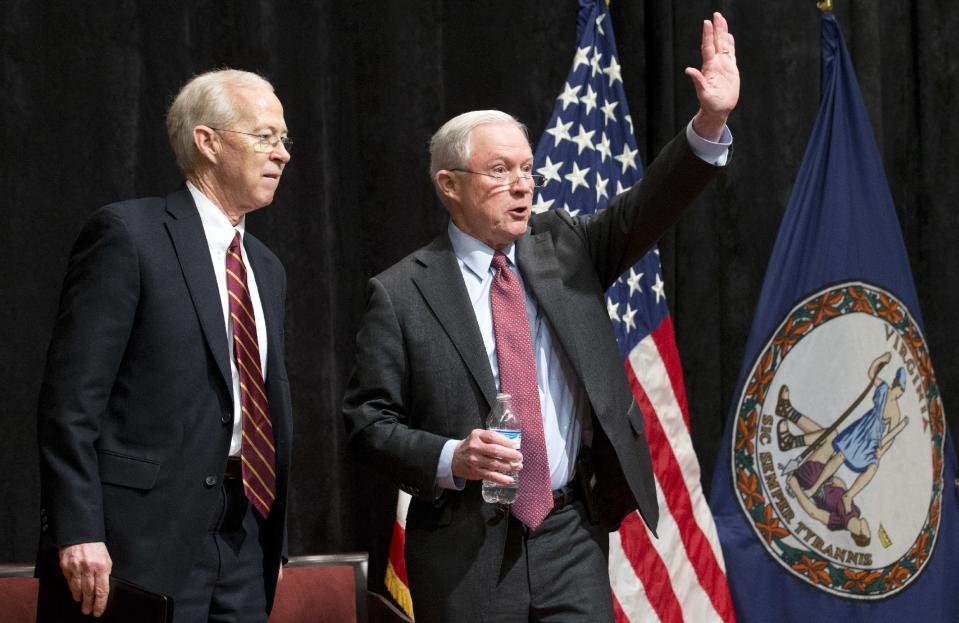 Attorney General Jeff Sessions, right, accompanied by Deputy Attorney General Dana Bonte, waves after speaking to law enforcement officers in Richmond, Va., Wednesday, March 15, 2017. (AP Photo/Steve Helber)