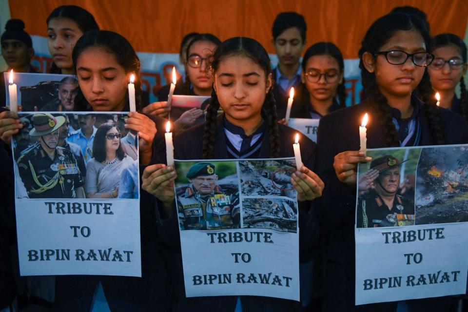 Students hold light candles and posters to pay their tribute to India’s defense chief General Bipin Rawat, who was killed with 13 others a day earlier in a helicopter crash (AFP via Getty Images)