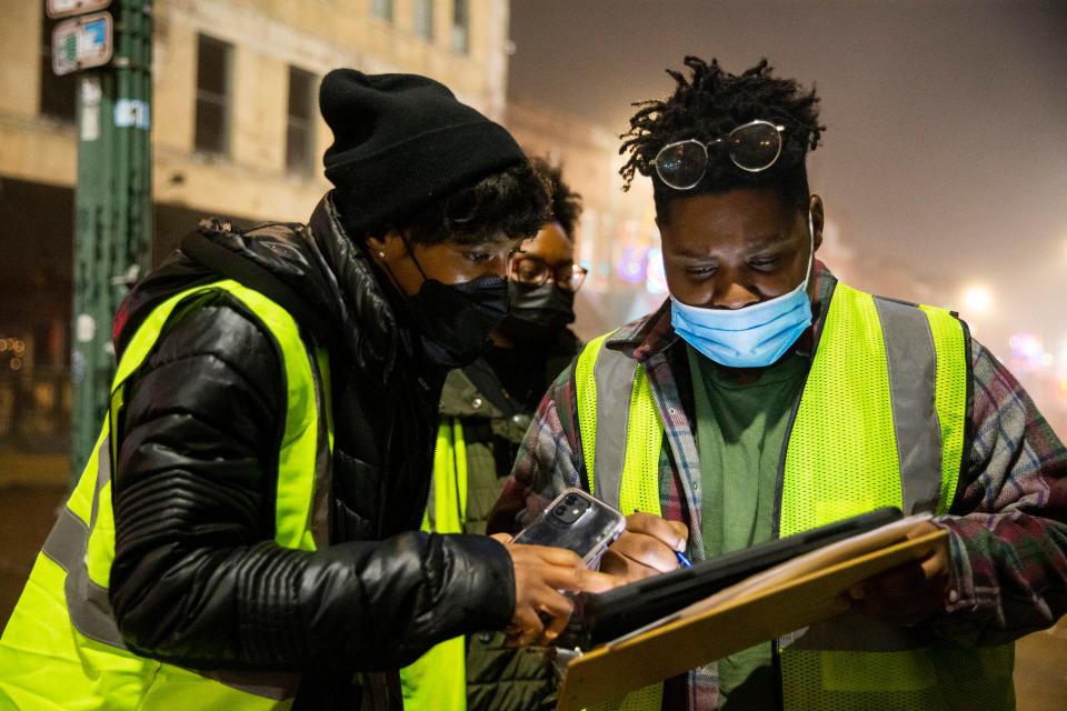 Crystal Anthony and Andorian Thomas, staff from Project for Assistance in Transition from Homelessness with CMI Healthcare Services, look over questions from the survey they are required to ask each unhoused person they count as they stand on Beale Street while taking part in the annual point-in-time count led by Community Alliance for the Homeless in Memphis, Tenn., on Thursday, January 25, 2024.