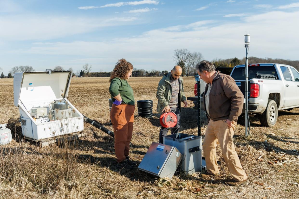 Michigan State University Research Assistant Samantha Smith, left, and MSU Ph.D. student Babak Dialameh, center, both members of the MSU Extension Drainage Research Team, meet
with Michigan corn and soybean farmer Jim Isley to discuss data resulting from an ongoing research partnership.