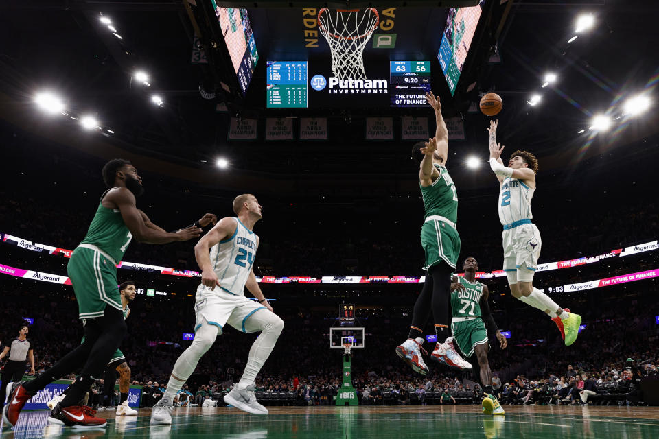 Charlotte Hornets' LaMelo Ball goes up for a shot over Boston Celtics' Enes Freedom during the second half of an NBA basketball game Wednesday, Jan. 19, 2022, in Boston. (AP Photo/Winslow Townson)