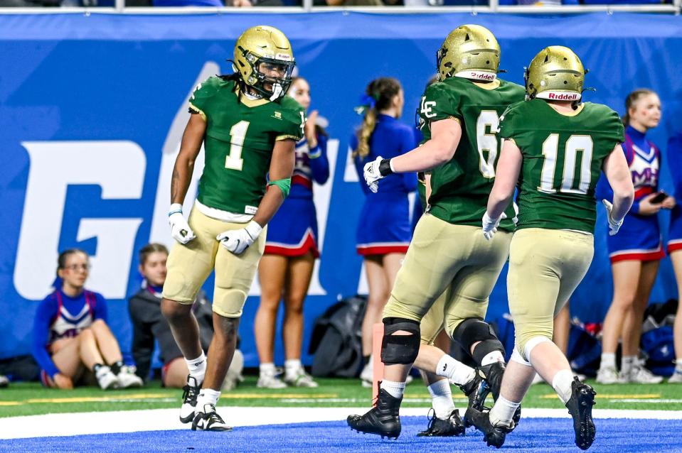 Jackson Lumen Christi's Kadale Williams, left, celebrates his touchdown against Menominee during the second quarter on Sunday, Nov. 26, 2023, at Ford Field in Detroit.