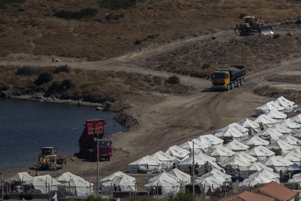 A general view of the temporary camp for refugees and migrants near Mytilene town, on the northeastern island of Lesbos, Greece, Sunday Sept. 13, 2020. Greek authorities have been scrambling to find a way to house more than 12,000 people left in need of emergency shelter on the island after the fires deliberately set on Tuesday and Wednesday night gutted the Moria refugee camp.(AP Photo/Petros Giannakouris)