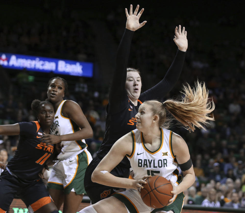 Baylor forward Lauren Cox, right, drives on Oklahoma State center Kassidy De Lapp, left, in the second half of an NCAA college basketball game, Sunday, Jan. 12, 2020, in Waco, Texas. (Rod Aydelotte/Waco Tribune Herald via AP)