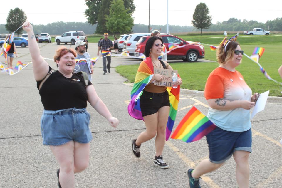 SAGE member Kendall Trinka marches with others to the Fowlerville Board of Education meeting on Tuesday, Aug. 1, 2023.