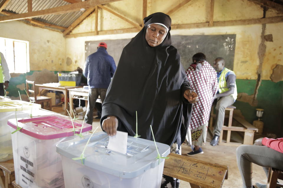 A woman casts her vote in Kenya's general election in Sugoi, 50 kms (35 miles) north west of Eldoret, Kenya, Tuesday Aug. 9, 2022. Kenyans are voting to choose between opposition leader Raila Odinga Deputy President William Ruto to succeed President Uhuru Kenyatta after a decade in power. (AP Photo/Brian Inganga)