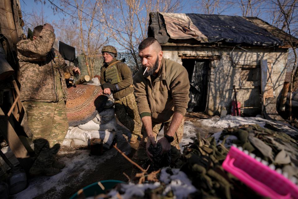 A Ukrainian serviceman washes clothes at a front-line position outside Popasna in eastern Ukraine on Monday.