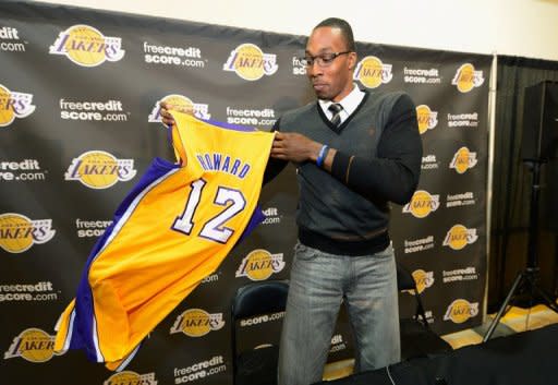 Dwight Howard shows his new jersey after being introduced to the media as the newest member of the Los Angeles Lakers in El Segundo, California, in August 2012. Newcomers Howard and Steve Nash joined the Los Angeles Lakers for Monday's first day of training camp as Kobe Bryant looks for a sixth career NBA title and Pau Gasol bids for his third