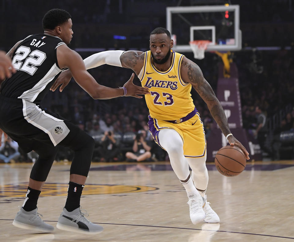 Lakers forward LeBron James drives toward the basket against Spurs forward Rudy Gay during the first half Monday night. (AP)