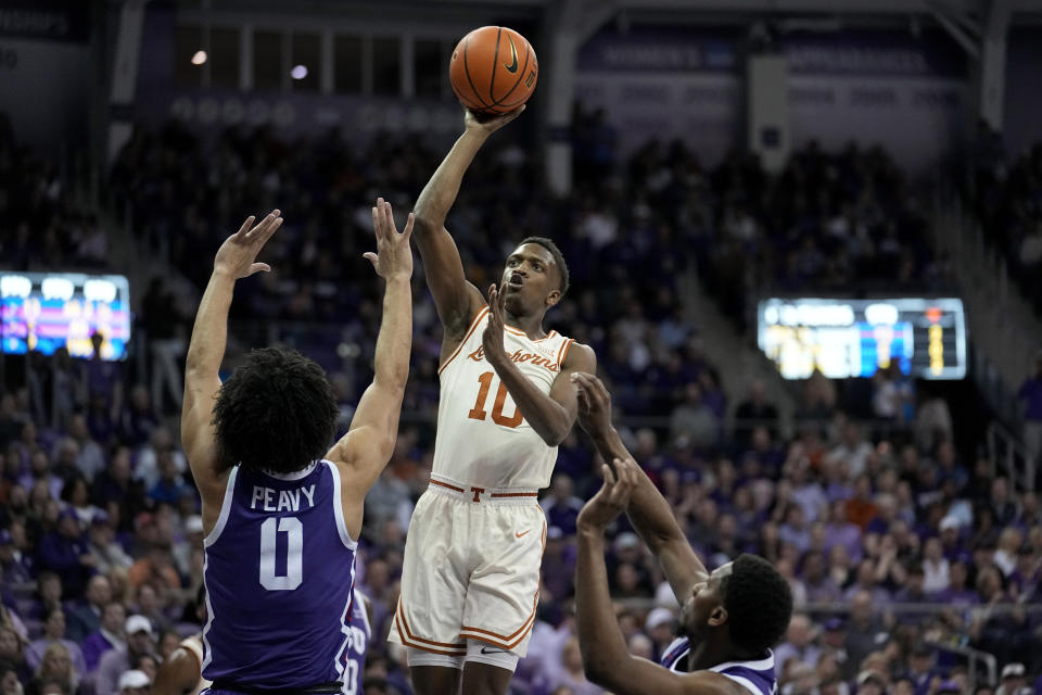 Texas guard Sir'Jabari Rice (10) takes a shot over TCU guard Micah Peavy (0) in the first half of an NCAA college basketball game, Wednesday, March 1, 2023, in Fort Worth Texas. (AP Photo/Tony Gutierrez)