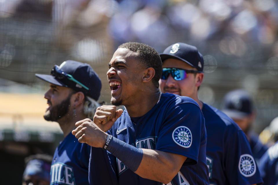 Seattle Mariners' Julio Rodriguez, center, reacts after Jesse Winker scored the go-ahead run against the Oakland Athletics during the ninth inning of a baseball game in Oakland, Calif., Thursday, June 23, 2022. (AP Photo/John Hefti)