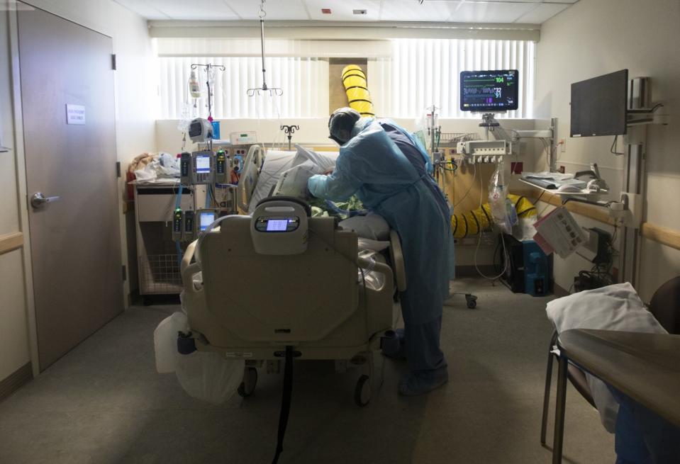 Joseph Demesa, RCP Respiratory Services, works with a patient