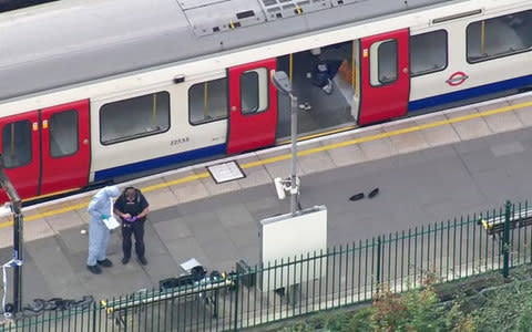 forensic officers work at the Parsons Green Underground Station after an explosion - Credit: PA