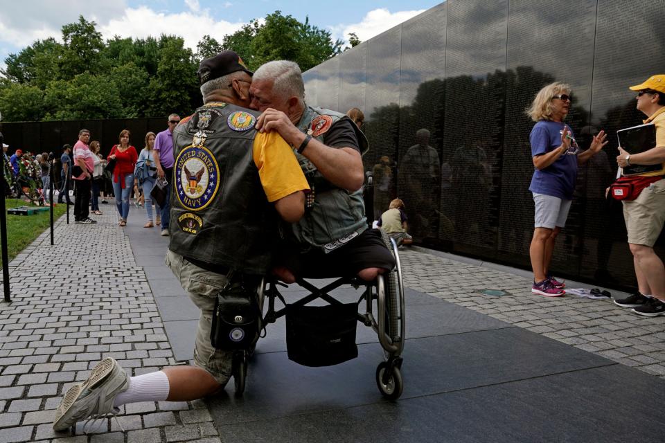 <p>In town for the Memorial Day weekend, Vietnam War veterans Jim Corrales (L) of Fontana, California and Mike Hodge of Seattle, Washington, comfort one another in front of the Vietnam Veterans Memorial in Washington, U.S., May 26, 2017. (Photo: Kevin Lamarque/Reuters) </p>