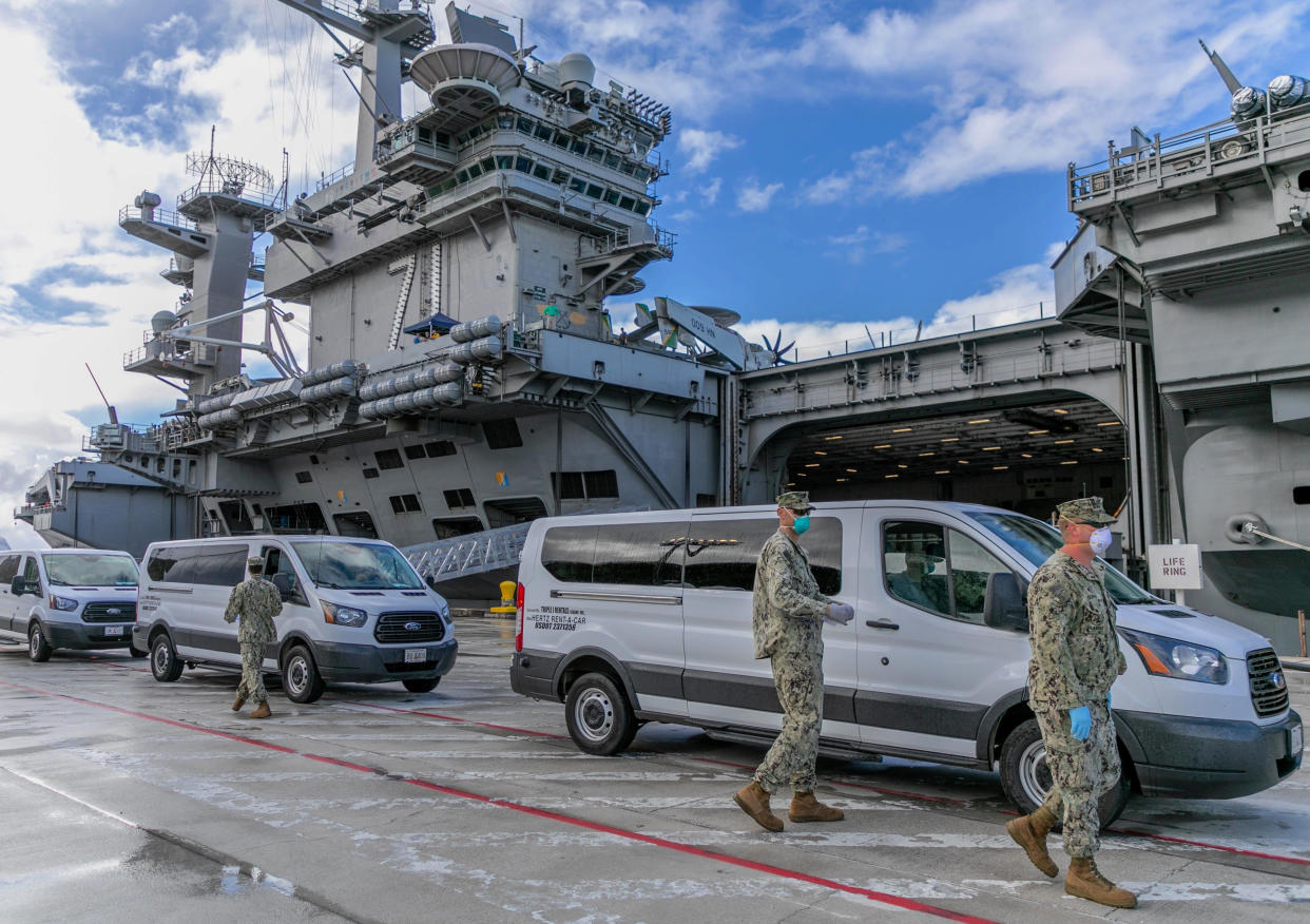 Seabees coordinate transportation of Sailors assigned to the aircraft carrier USS Theodore Roosevelt