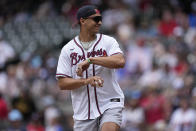 Atlanta Falcons quarterback Desmond Ridder throws out the ceremonial first pitch before a baseball game between the Seattle Mariners and Atlanta Braves, Sunday, May 21, 2023, in Atlanta. (AP Photo/John Bazemore)