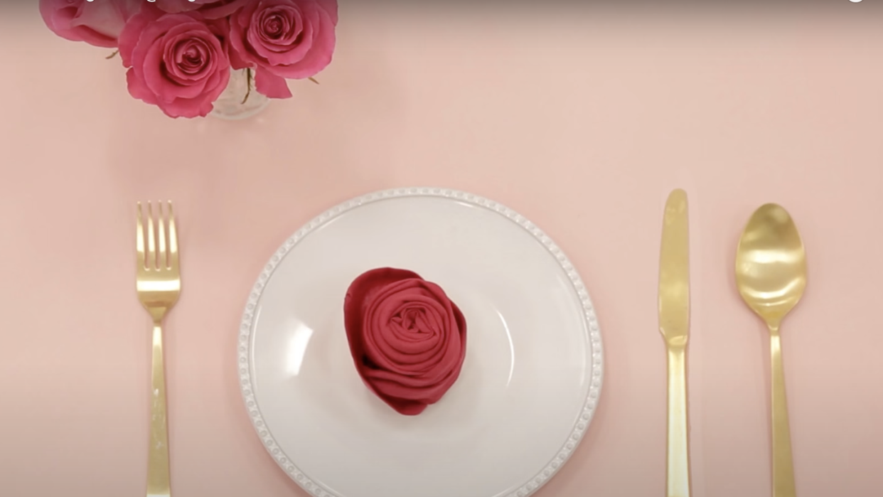 rose napkin on plate