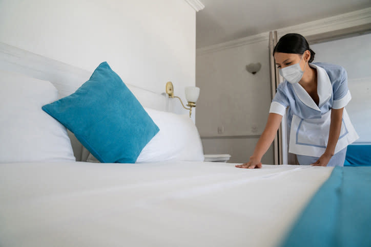 A maid cleaning a hotel room