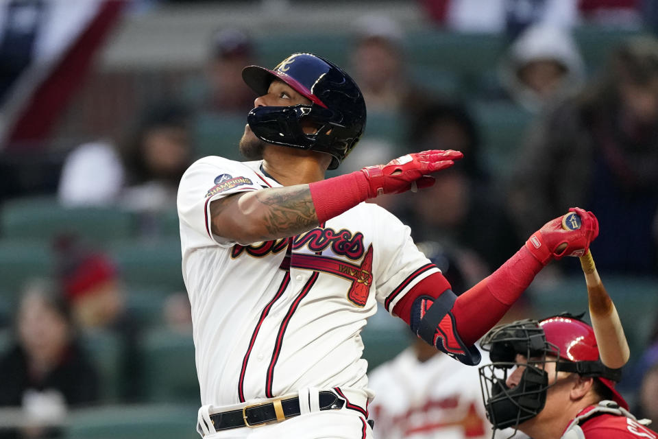Atlanta Braves shortstop Orlando Arcia (11) drives in a run with a sacrifice fly in the second inning of a baseball game against the Cincinnati Reds Friday, April 8, 2022, in Atlanta. (AP Photo/John Bazemore)