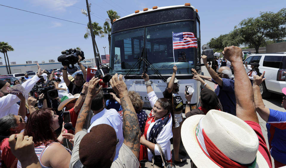 <p>Demonstrators block a bus with immigrant children onboard during a protest outside the U.S. Border Patrol Central Processing Center Saturday, June 23, 2018, in McAllen, Texas. Extra law enforcement officials were called in to help control the scene and allow the bus to move. (Photo: David J. Phillip/AP) </p>