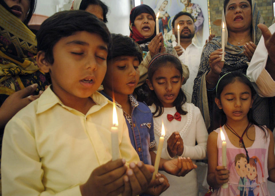 Pakistani Christians attend a special prayer service for the victims of Christchurch mosques shooting, at a church in Hyderabad, Pakistan, Sunday, March 17, 2019. Pakistan's foreign ministry spokesman says three more Pakistanis have been identified among the dead increasing the number of Pakistanis to nine killed in the mass shootings at two mosques in the New Zealand city of Christchurch. (AP Photo/Pervez Masih)