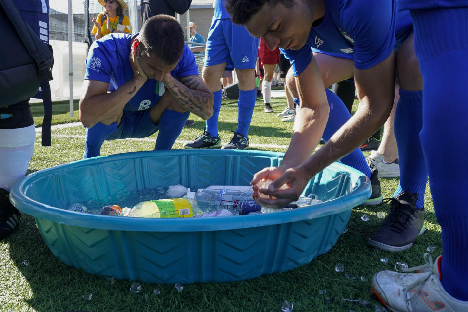 Italy players cool off before playing a match at the Homeless World Cup, Tuesday, July 11, 2023, in Sacramento, Calif. (AP Photo/Godofredo A. Vásquez)