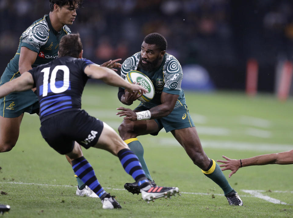 Australia's Marika Koroibete, right, charges toward Argentina's Nicolas Sánchez during their Tri-Nations rugby union match in Sydney, Australia, Saturday, Dec. 5, 2020. (AP Photo/Rick Rycroft)