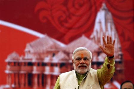 Narendra Modi, prime ministerial candidate for India's main opposition Bharatiya Janata Party (BJP) and Gujarat's chief minister, waves to his supporters during a public meeting at Somnath in Gujarat February 1, 2014. REUTERS/Amit Dave