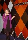 This Feb. 9, 2014 photo shows Anne D’Innocenzio performing at a standup comedy show at Caroline's Comedy Club in New York after taking a six-week class in standup comedy. The $395 course, held at a nearby acting studio, culminates with a graduation performance at the club for friends and family. (AP Photo/Lawrence Roberts)