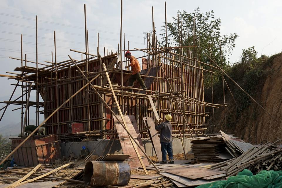 This picture taken on February 8, 2020 shows Chinese workers building the first rail line linking China to Laos, a key part of Beijing's 'Belt and Road' project across the Mekong, in Luang Prabang. - From an artificial island in Sri Lanka to a bridge in Bangladesh and hydropower projects in Nepal and Indonesia, China's trillion-dollar Belt and Road plan is stuttering under the effects of the deadly coronavirus. (Photo by Aidan JONES / AFP) / TO GO WITH Health-virus-diplomacy-trade-China-SAsia, FOCUS by Poornima WEERASEKARA and Safiqul ALAM (Photo by AIDAN JONES/AFP via Getty Images)