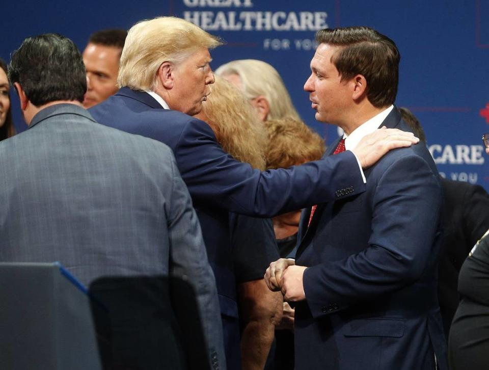 In 2019, then-President Donald Trump talks to Florida Gov. Ron DeSantis after giving a speech to his supporters at the Sharon L. Morse Performing Arts Center in The Villages, Fla. Octavio Jones/Tampa Bay Times / TNS