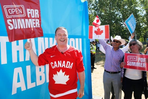 Alberta Premier Jason Kenney celebrates the lifting of public health restrictions by taking part in Canada Day celebrations in Calgary on July 1. (Larry MacDougal/The Canadian Press - image credit)