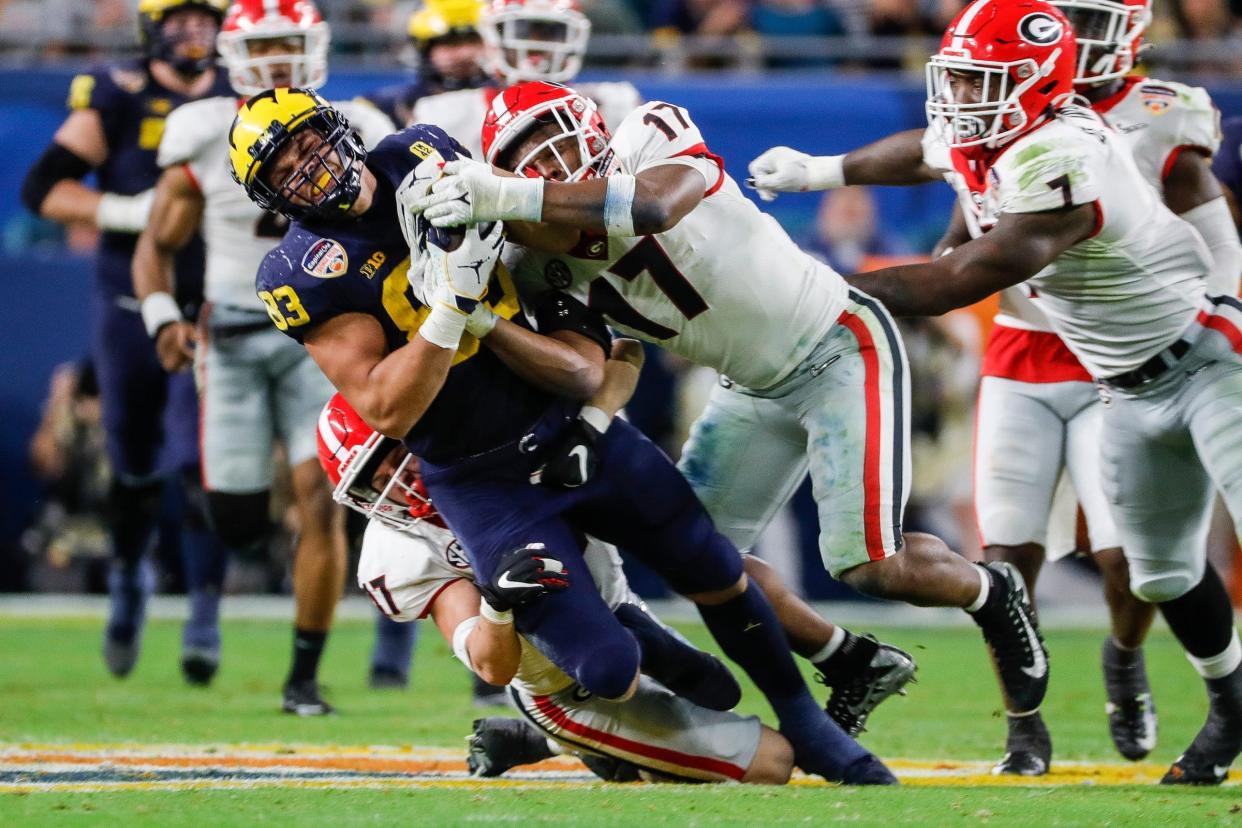 Michigan tight end Erick All (83) makes a catch against Georgia linebacker Nakobe Dean (17) during the second half of the Orange Bowl at Hard Rock Stadium in Miami Gardens, Florida, on Friday, Dec. 31, 2021.