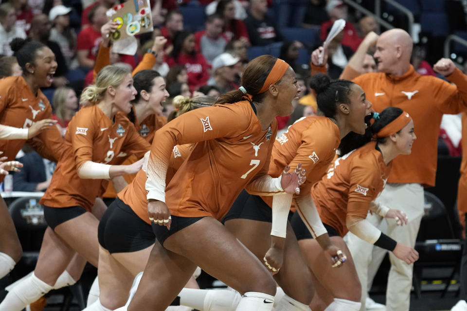 Texas players react after the team defeated Wisconsin during a semifinal match in the NCAA Division I women's college volleyball tournament Thursday, Dec. 14, 2023, in Tampa, Fla. (AP Photo/Chris O'Meara)