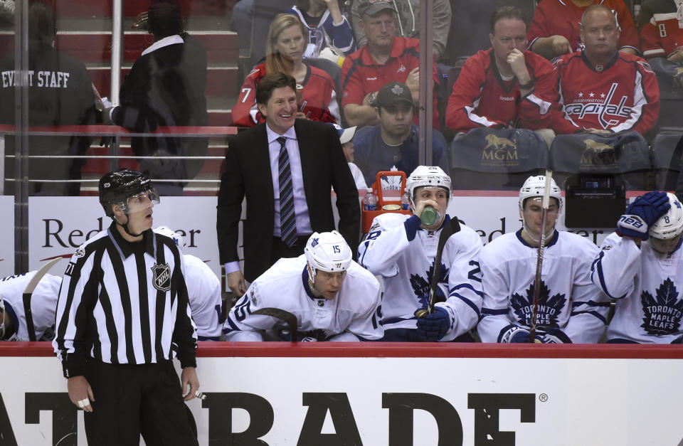 Toronto Maple Leafs coach Mike Babcock smiles from the bench during the first overtime period against the Washington Capitals in Game 2 of an NHL Stanley Cup first round playoff series in Washington, Saturday, April 15, 2017. Toronto won 4-3 in two overtimes. (AP Photo/Molly Riley)