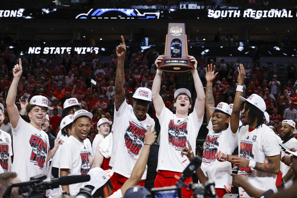 North Carolina State's Ben Middlebrooks holds up the South Regional trophy following an Elite Eight college basketball game against Duke in the NCAA Tournament in Dallas, Sunday, March 31, 2024. North Carolina State won 76-64. (AP Photo/Brandon Wade)
