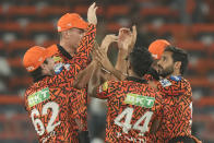 Sunrisers Hyderabad's Bhuvneshwar Kumar, right, celebrates with teammates the wicket of Rajasthan Royals' Jos Buttler during the Indian Premier League cricket match between Sunrisers Hyderabad and Rajasthan Royals in Hyderabad, India, Thursday, May 2, 2024. (AP Photo/Mahesh Kumar A.)