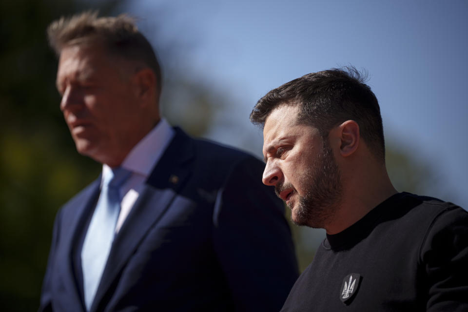 Ukraine's President Volodymyr Zelenskyy, right, attends a welcoming ceremony at the Cotroceni Presidential Palace together with Romanian President Klaus Iohannis, in Bucharest, Romania, Tuesday, Oct. 10, 2023. (AP Photo/Andreea Alexandru)