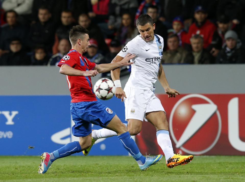 Manchester City's Aleksandr Kolarov (R) challenges Viktoria Plzen's Milan Petrzela during their Champions League group D soccer match at the Doosan Arena in Prague, Czech Republic September 17, 2013. REUTERS/Petr Josek (CZECH REPUBLIC - Tags: SPORT SOCCER)