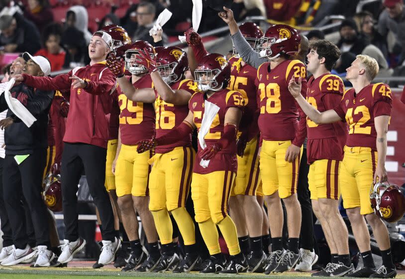 USC players celebrate on the sideline while playing California