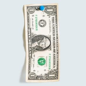 one dollar bill pinned with a blue thumbtack