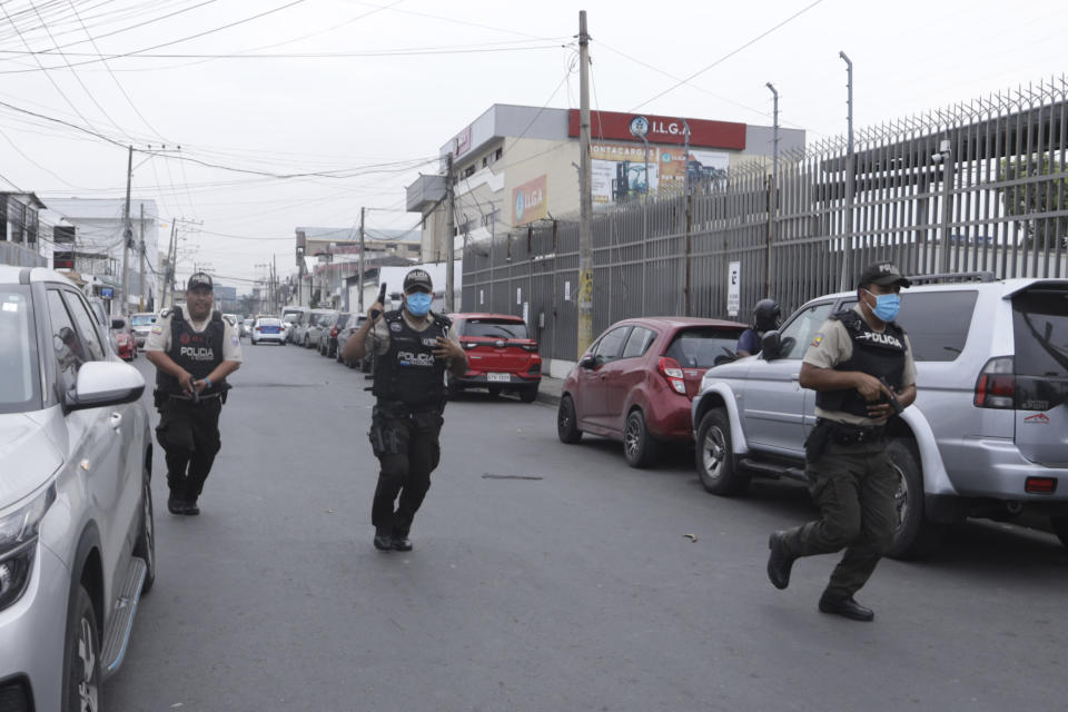 Police respond to an attack at the TC Television network, a public television channel in Guayaquil, Ecuador, Tuesday, Jan. 9, 2024. Masked men broke onto the set waving guns and explosives during a live broadcast Tuesday. (AP Photo/Cesar Munoz)
