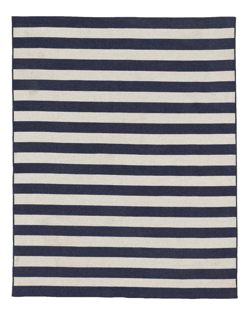 This undated publicity photo provided by Restoration Hardware Baby and Child shows a bold striped, braided wool rug, a great way to introduce navy to a room (www.rhbabyandchild.com). With bold pops of color, or a few soothing neutrals, navy is a fresh trend worth exploring this spring. (AP Photo/Restoration Hardware Baby and Child)