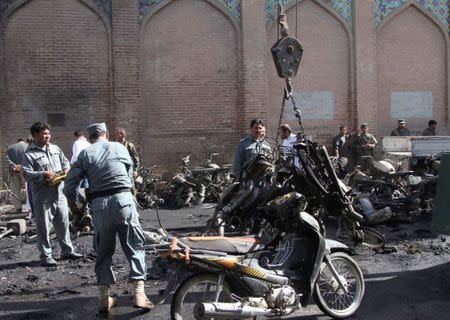 Afghan policemen inspects at the site of a blast in Herat, Afghanistan June 6, 2017. REUTERS/Mohammad Shoib