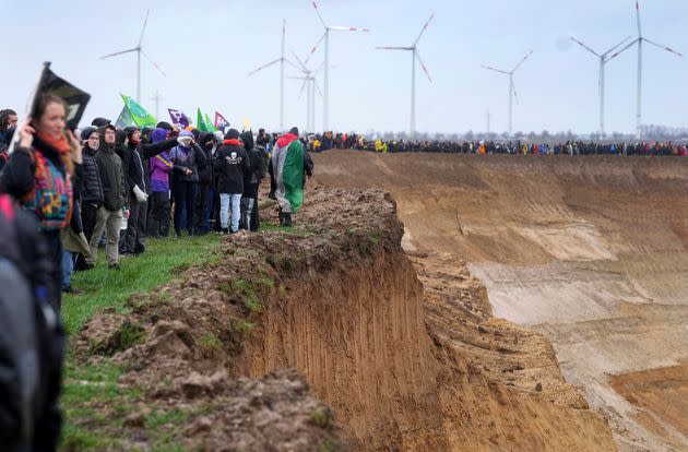People attend a protest rally at the Garzweiler mine near the village Luetzerath in Erkelenz, Germany, Saturday, Jan. 14, 2023.